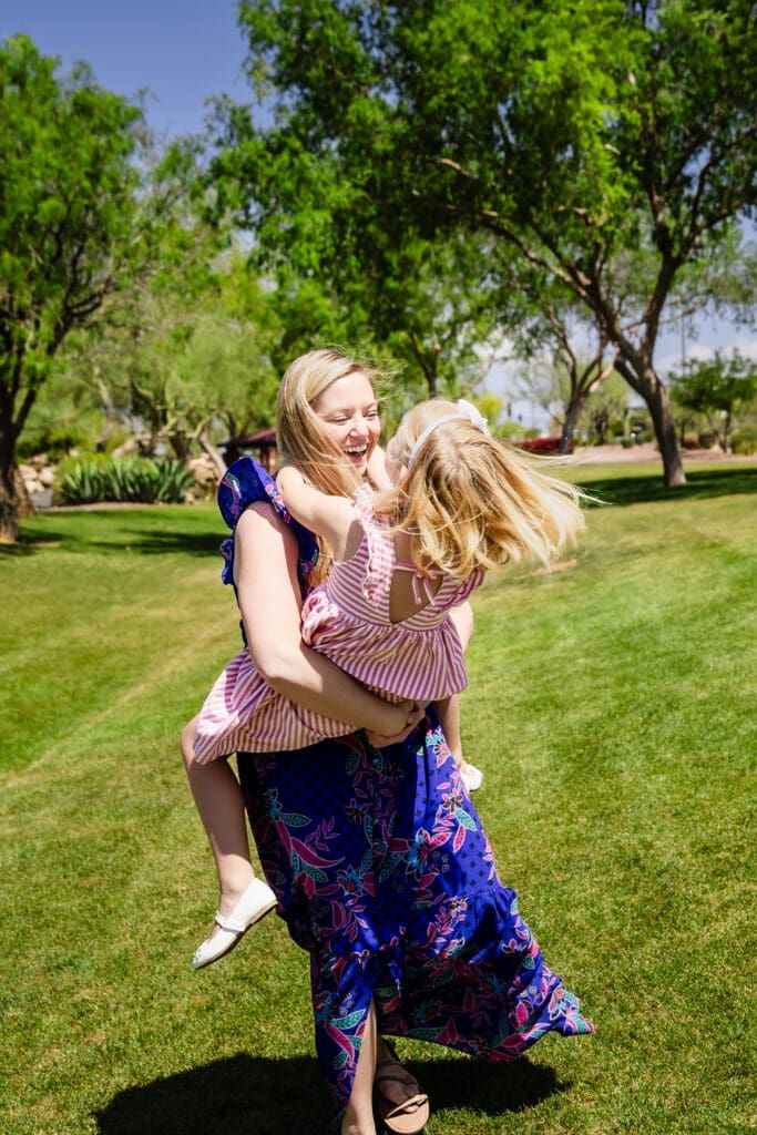 Mother holding her daughter during a candid family photo session at Anthem Community Park in Anthem, Arizona.