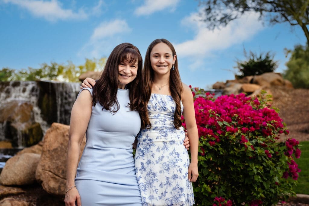 Mother and daughter posing beside the waterfall at Anthem Community Park