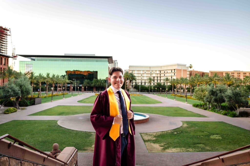 ASU graduate posing near the fountain at Tempe campus