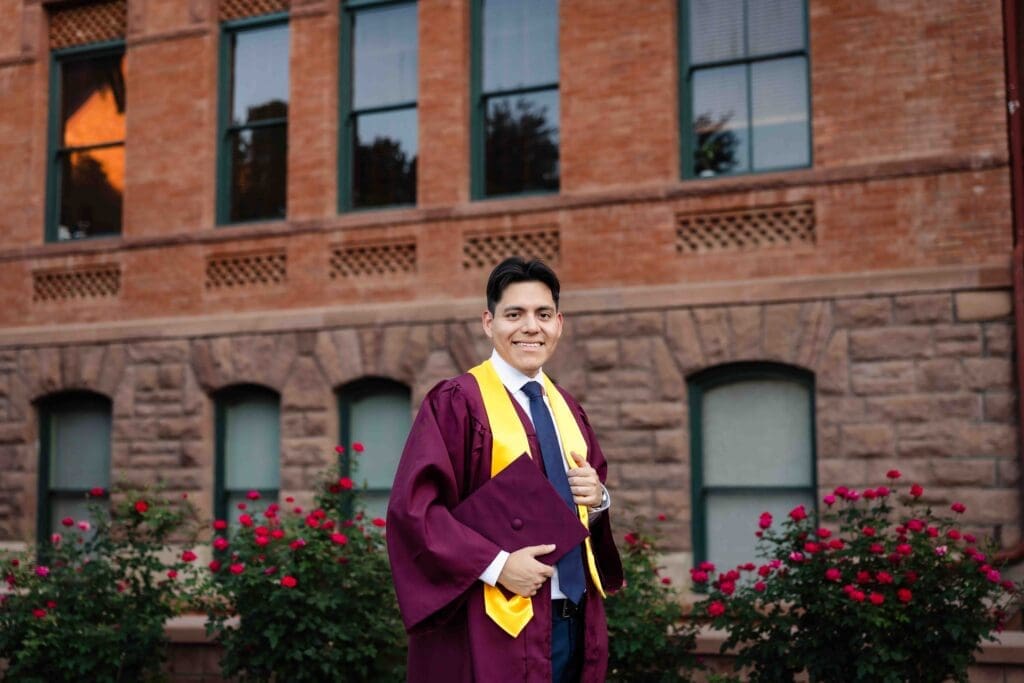 ASU graduate portrait near roses at Old Main