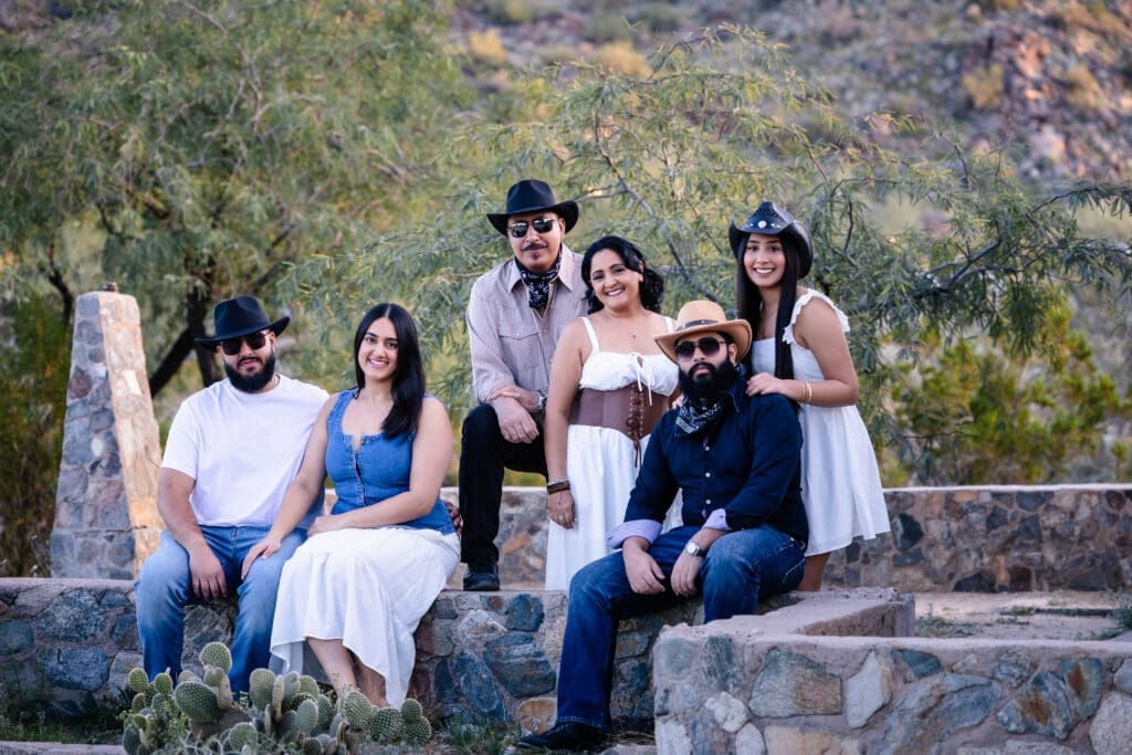 Family sitting together on the stone steps at Scorpion Gulch during a photo session at South Mountain in Phoenix, Arizona.