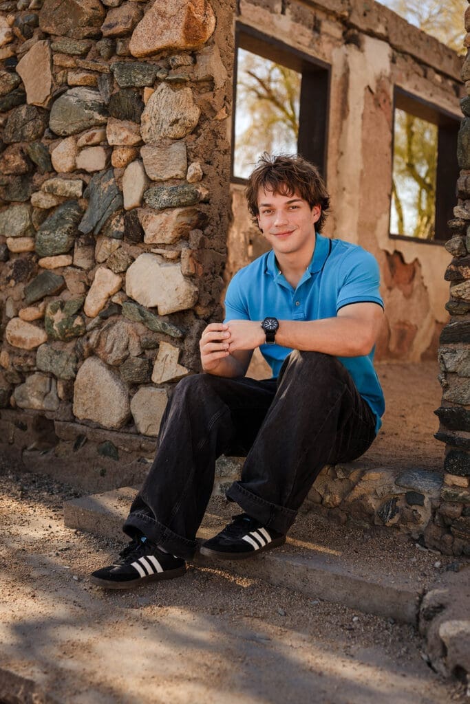 Senior sitting on the stone steps at Scorpion Gulch during a portrait session at South Mountain in Phoenix, Arizona.