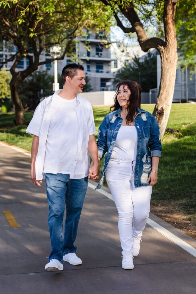 Couple walking together during engagement photos in Tempe Arizona