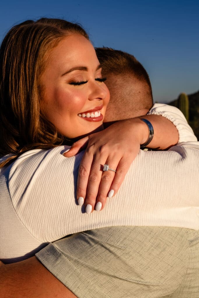 Close-up of an engaged couple hugging with an engagement ring visible during a Usery Mountain photo session near Mesa, Arizona.